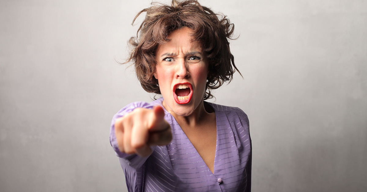 angry woman in purple dress pointing and shouting