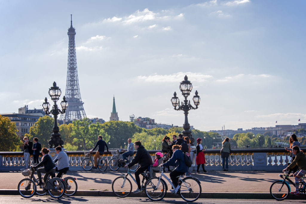 various people biking through the streets of Paris, France