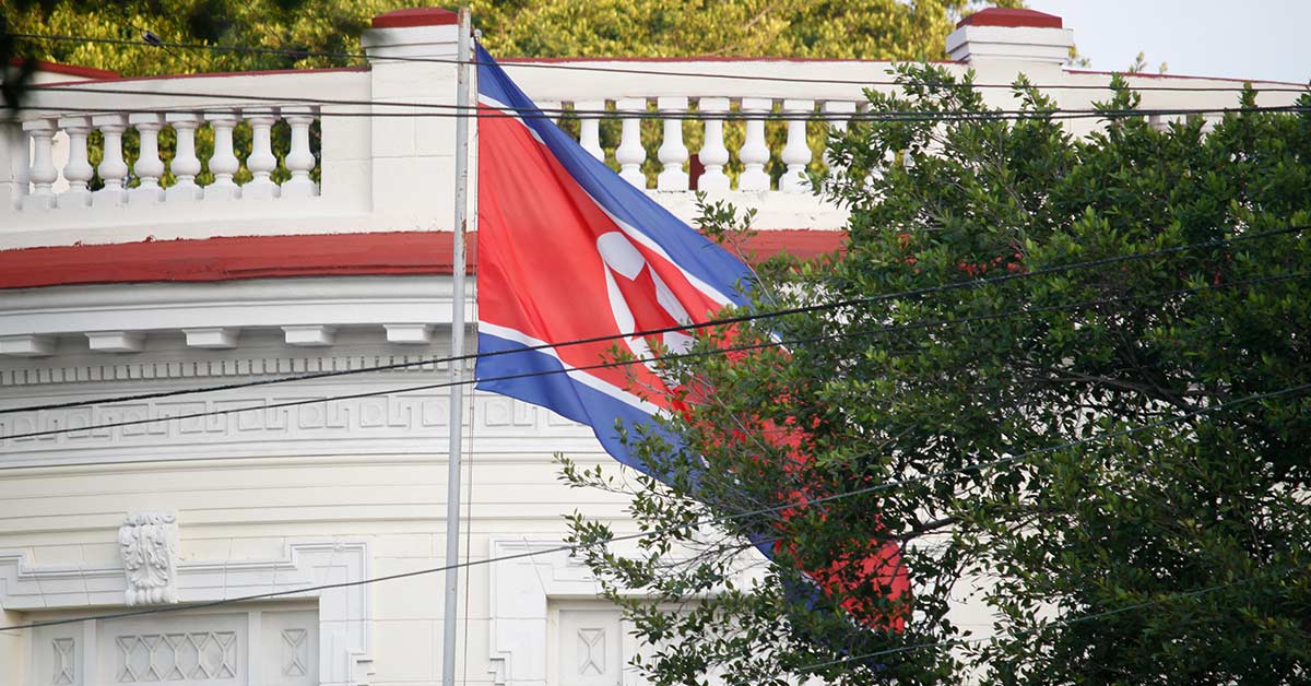 North Korean flag outside of white building