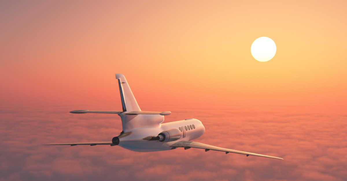 passenger jet flying at high altitude at sunset