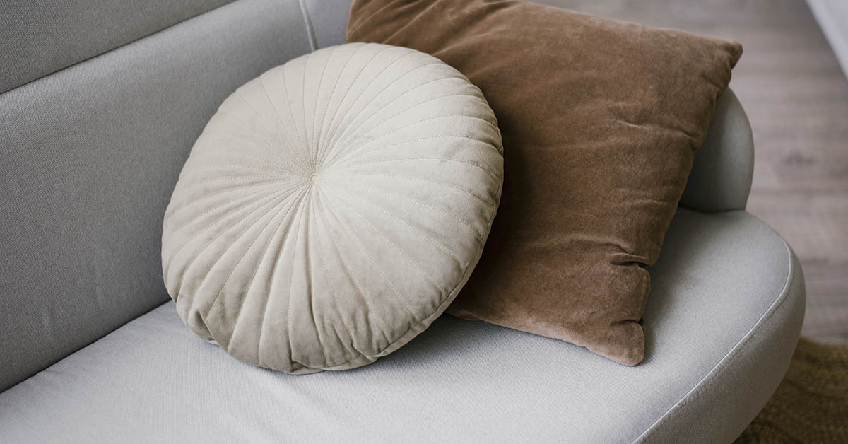 couch with a brown square, and white circular decorative pillows